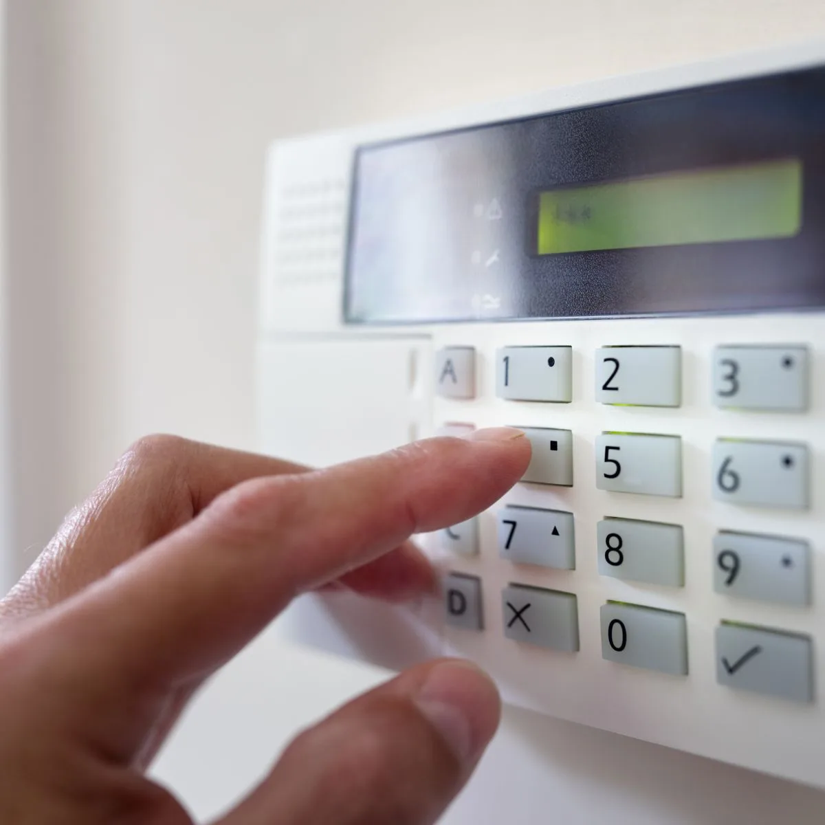 Technician installing a commercial alarm system for an Ontario business